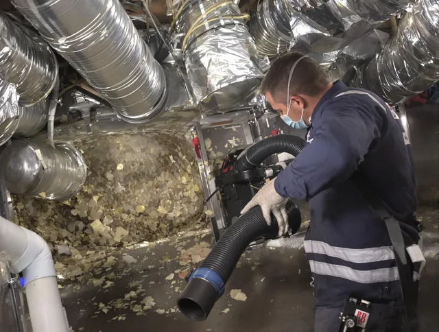 East Bridgewater Air Duct Cleaning specialist operating negative pressure cleaning equipment for thorough duct maintenance in East Bridgewater